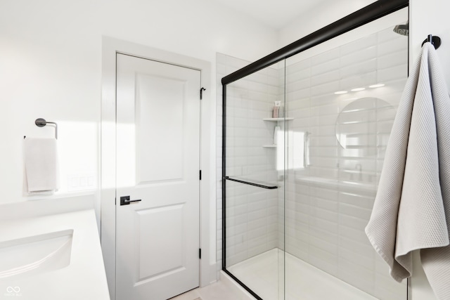 bathroom featuring sink and an enclosed shower