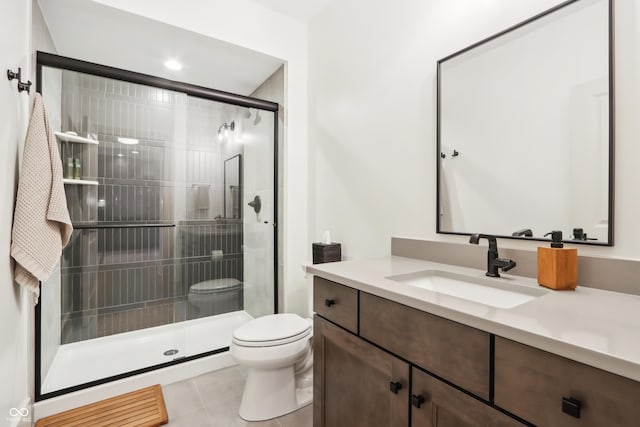 bathroom with tile patterned floors, vanity, toilet, and a shower with shower door