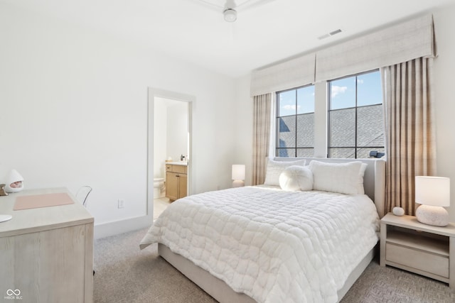 carpeted bedroom featuring connected bathroom