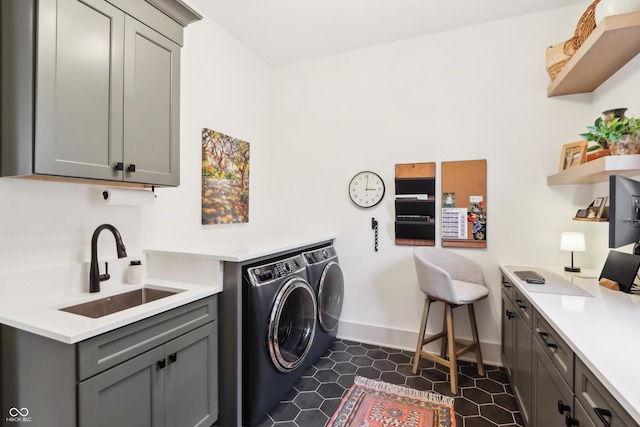 laundry area featuring cabinets, sink, and washing machine and clothes dryer