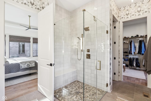 bathroom with ceiling fan and walk in shower