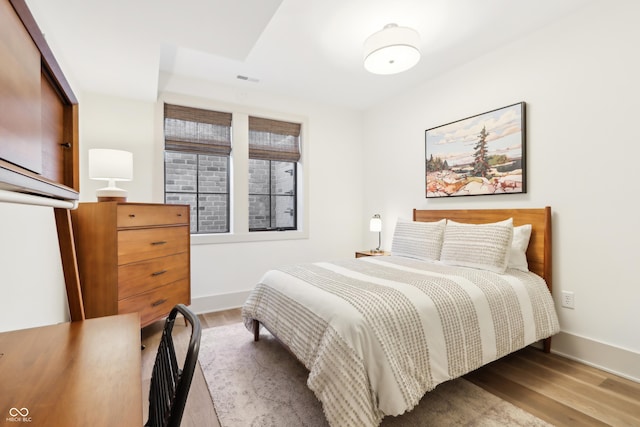 bedroom with wood-type flooring