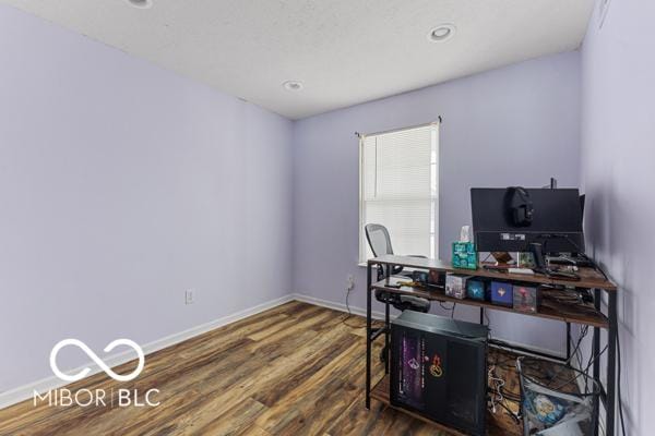 home office with dark hardwood / wood-style floors