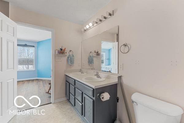 bathroom featuring vanity and toilet