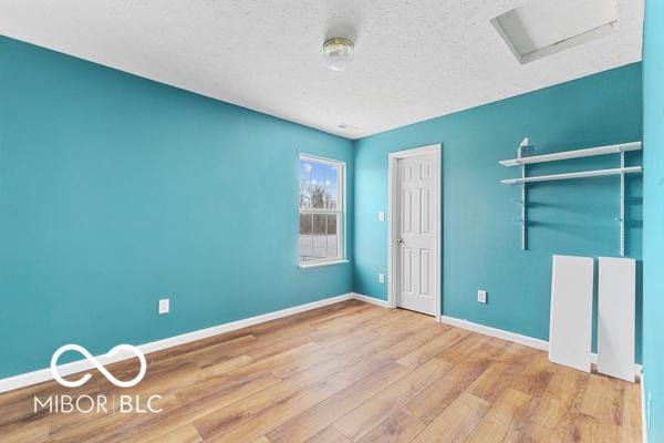 unfurnished bedroom with wood-type flooring and a textured ceiling