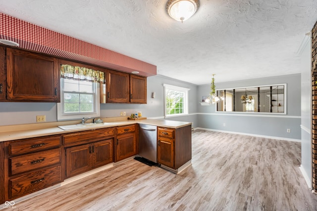 kitchen with stainless steel dishwasher, light wood-type flooring, and a wealth of natural light