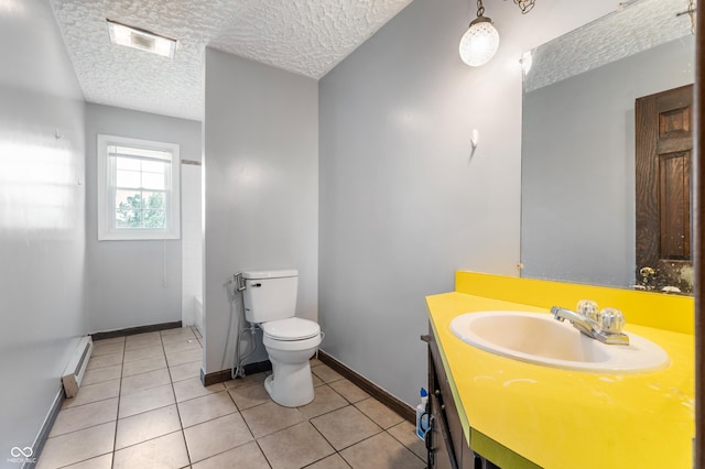 bathroom featuring tile patterned floors, vanity, a textured ceiling, baseboard heating, and toilet