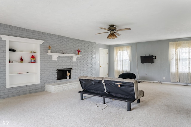 rec room featuring light carpet, a fireplace, ceiling fan, and built in features