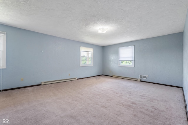 carpeted empty room featuring a textured ceiling and a baseboard radiator