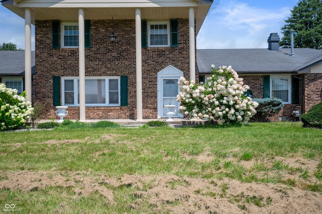 4832 E 200 N, Anderson, IN 46012 - neoclassical home with brick siding, a front yard, and a chimney