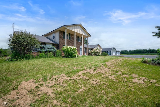 view of side of home with a yard