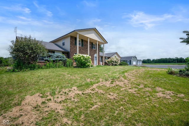 4832 E 200 N, Anderson, IN 46012 - view of front of home featuring brick siding, a front lawn, and driveway