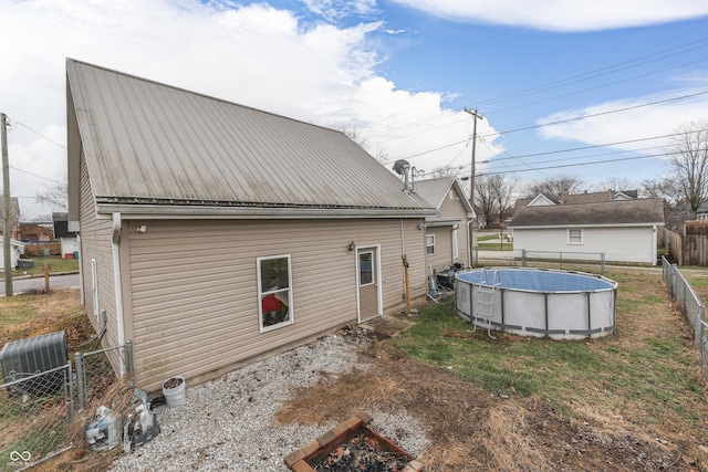 back of property featuring a fenced in pool