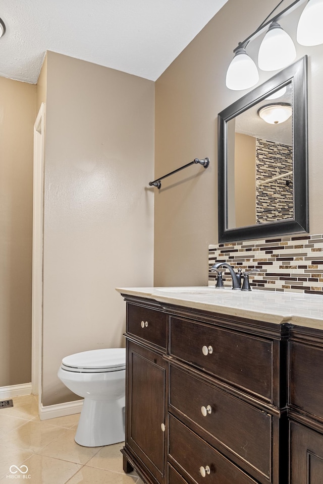 bathroom featuring tile patterned floors, decorative backsplash, toilet, and vanity