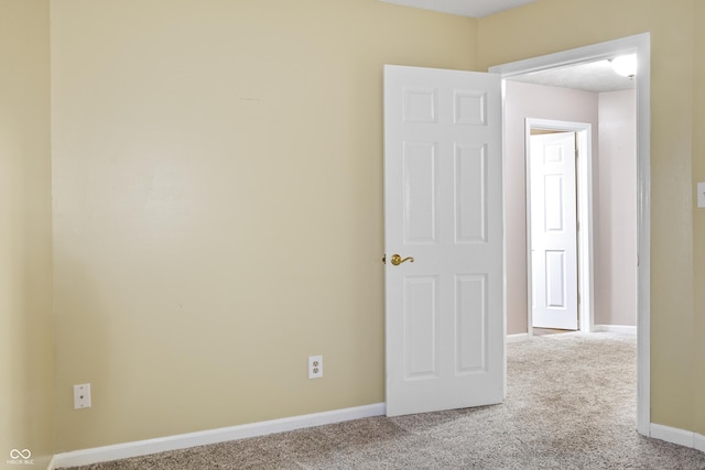 unfurnished room with light carpet