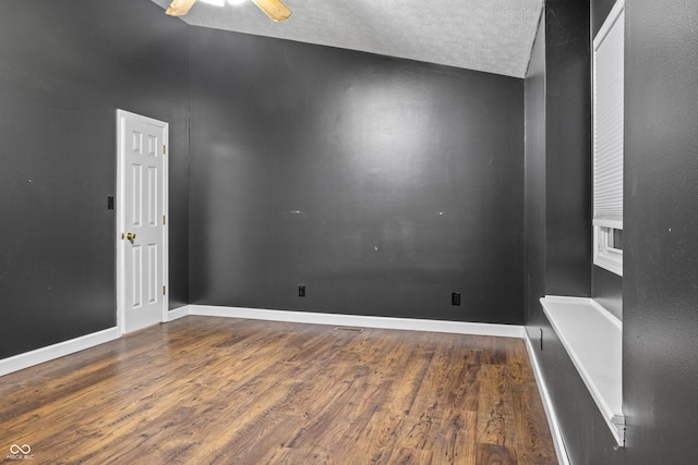 unfurnished room featuring ceiling fan, dark hardwood / wood-style flooring, and a textured ceiling