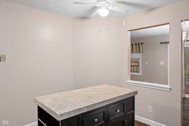 bathroom featuring hardwood / wood-style floors, ceiling fan, and a textured ceiling