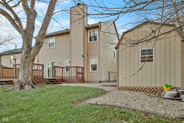 rear view of house with a lawn and a wooden deck