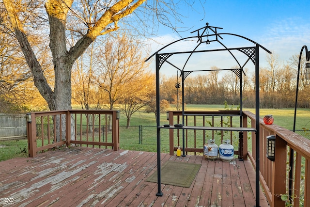 wooden terrace with a gazebo and a yard