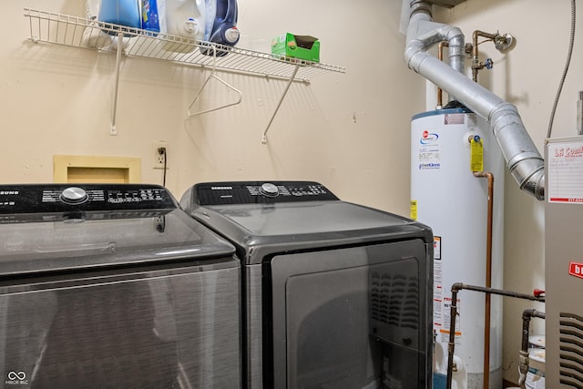 laundry area featuring water heater and independent washer and dryer