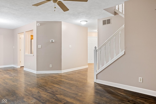 unfurnished room featuring a textured ceiling, dark hardwood / wood-style floors, and ceiling fan