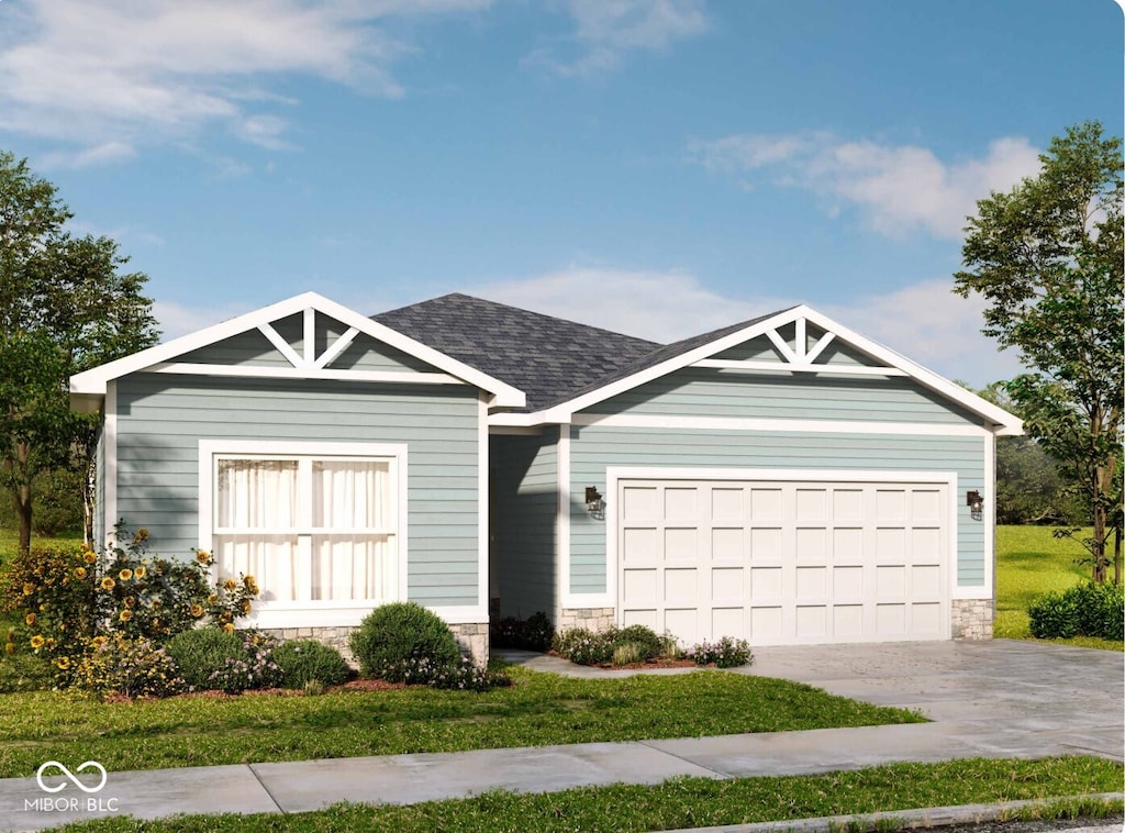 view of front of home with a garage and a front lawn