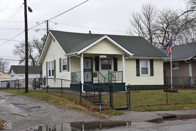 bungalow with a porch and a front yard