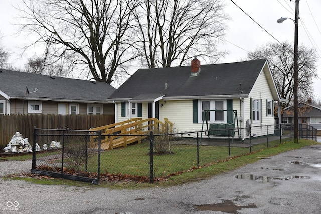 bungalow-style home with a front lawn