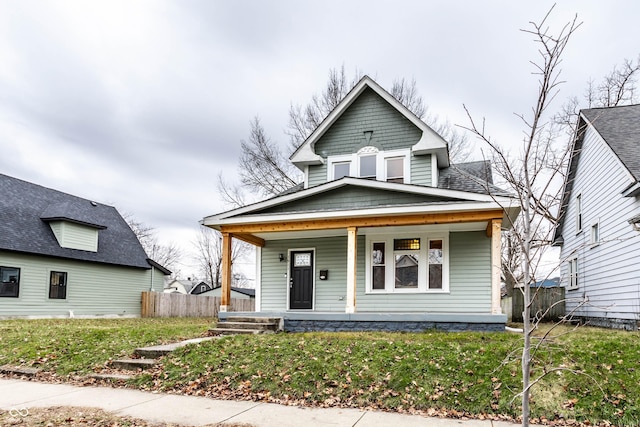 view of front of property featuring covered porch and a front yard