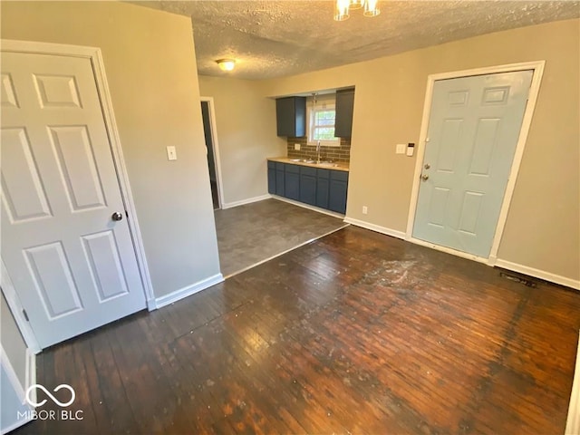 entryway with dark hardwood / wood-style flooring, a textured ceiling, and sink