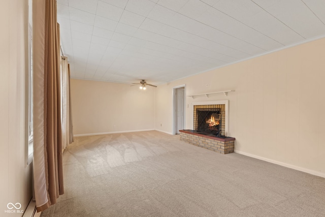 unfurnished living room featuring light carpet, a fireplace, ceiling fan, and crown molding