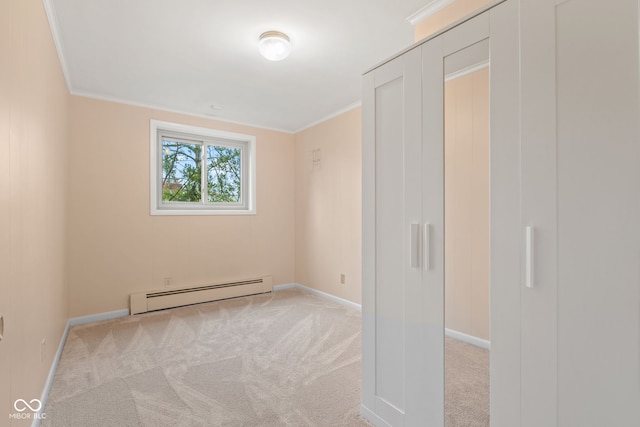 unfurnished room with light carpet, ornamental molding, and a baseboard heating unit