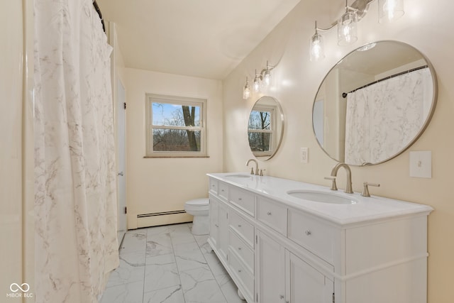 bathroom with vanity, toilet, and a baseboard heating unit