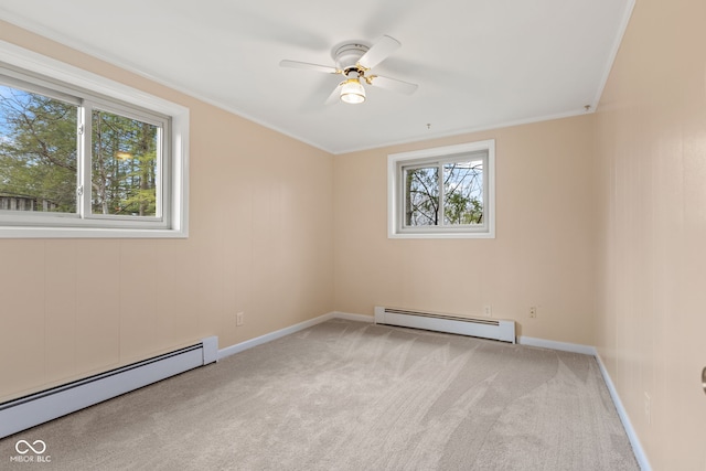 carpeted spare room with ceiling fan, ornamental molding, and a baseboard radiator