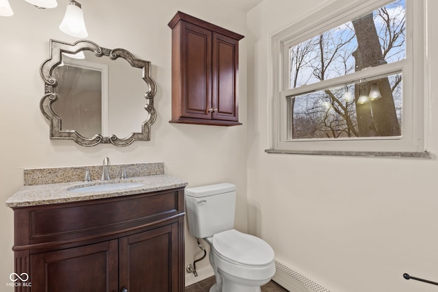 bathroom with vanity, toilet, and a baseboard heating unit