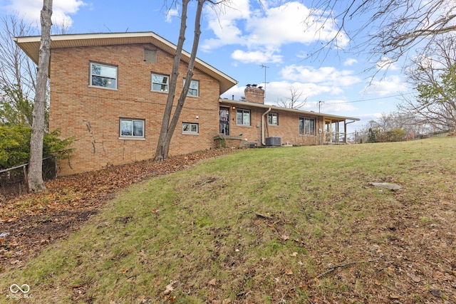 back of house with a yard and cooling unit