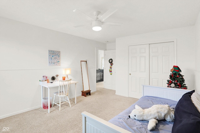 carpeted bedroom featuring ceiling fan and a closet