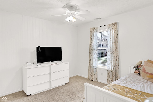 bedroom featuring ceiling fan and light carpet