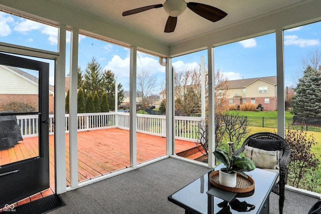 sunroom featuring ceiling fan and a healthy amount of sunlight