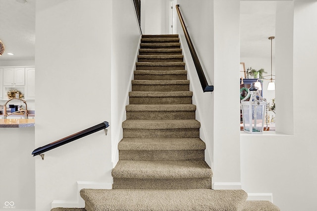 stairway with carpet flooring and sink