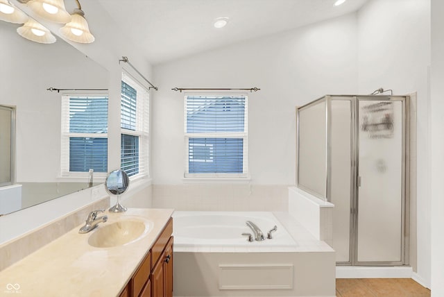 bathroom with separate shower and tub, tile patterned flooring, vanity, and lofted ceiling