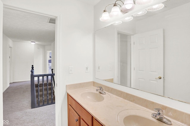 bathroom with vanity and a textured ceiling