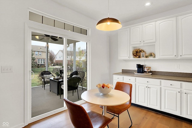 dining room featuring light hardwood / wood-style floors and ceiling fan