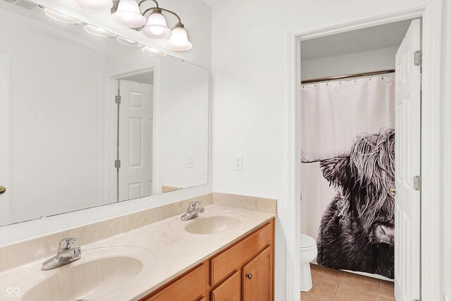 bathroom with tile patterned floors, vanity, and toilet