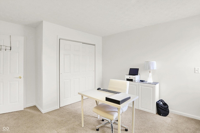 carpeted office with a textured ceiling