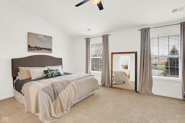 carpeted bedroom featuring ceiling fan and vaulted ceiling