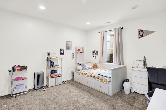 carpeted bedroom with radiator