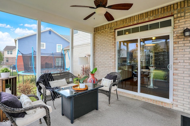 sunroom featuring ceiling fan