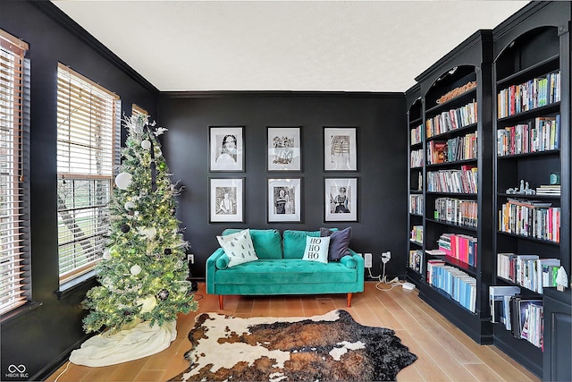 sitting room featuring hardwood / wood-style floors and ornamental molding