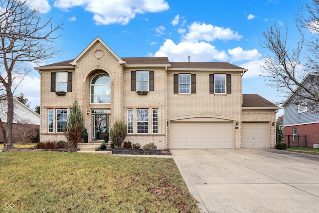 view of front of home with a garage and a front lawn